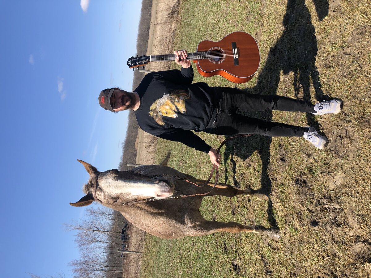 Chris with guitar — rural promo shot